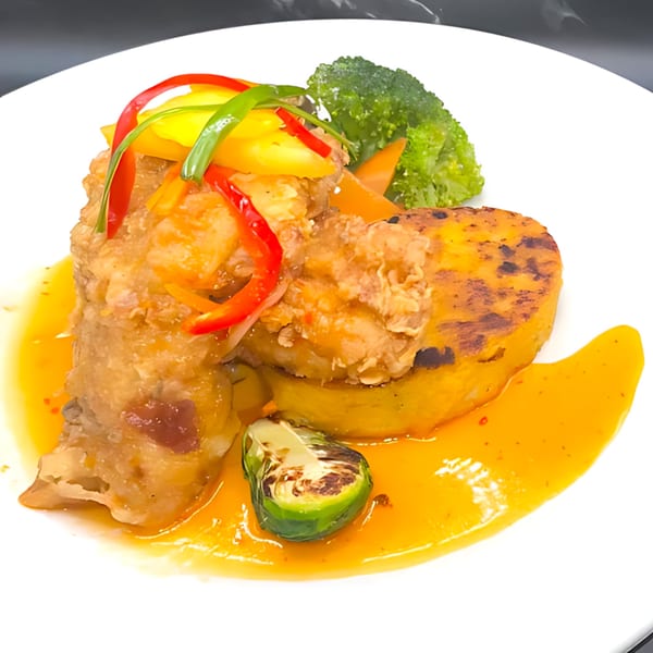 Crispy fried chicken with sweet chili sauce, grilled pumpkin, broccoli, and a Brussels sprout.